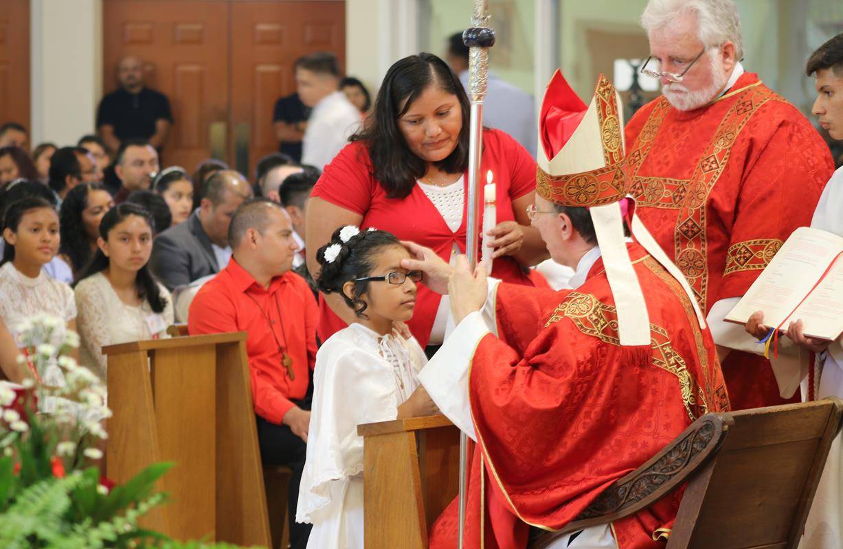 BOONVILLE — One hundred youths received the sacrament of confirmation at Divine Redeemer Church during a Mass offered June 9 by Bishop Peter Jugis. (Photos by Sergio Lopez)
