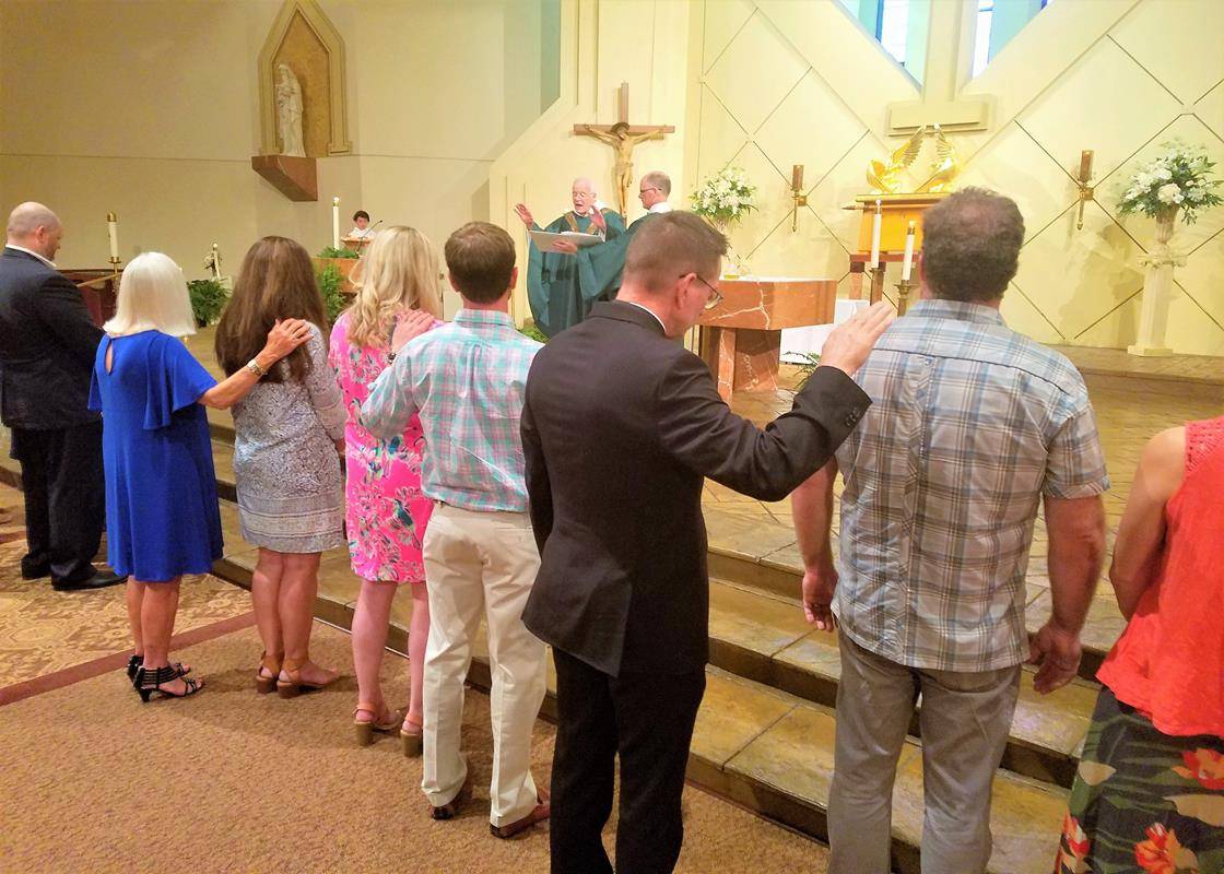 CHARLOTTE — “Be sealed with the gift of the Holy Spirit.” Eight members of St. Gabriel Church’s RCIA program received the sacrament of confirmation during Mass June 24 celebrated by Father Frank O’Rourke, pastor. (Photo provided by Darby McClatchy and Joh
