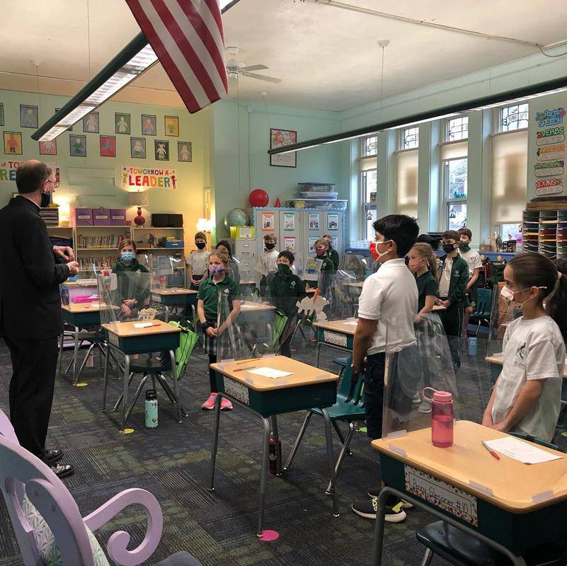 CARLOTTE — After celebrating Mass Feb. 1 for Catholic Schools Week, Bishop Peter Jugis visited classrooms at St. Patrick School with Father Christopher Roux. They helped kindergarten and 5th grade students with their service project. (Photos via FacebookH