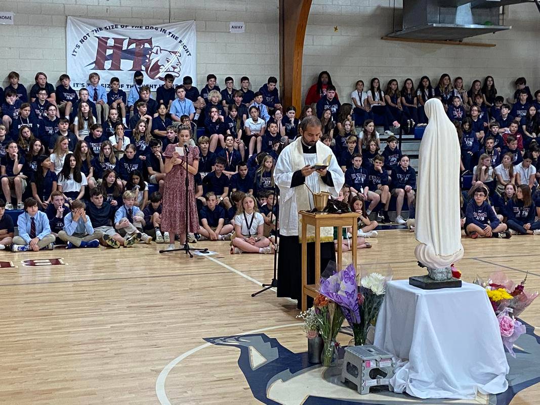 More than 100 sixth grade students stepped forward to receive the Brown Scapular during the May Crowning at Holy Trinity Middle School. (Provided photo)