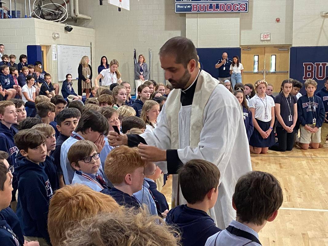 More than 100 sixth grade students stepped forward to receive the Brown Scapular during the May Crowning at Holy Trinity Middle School. (Provided photo)