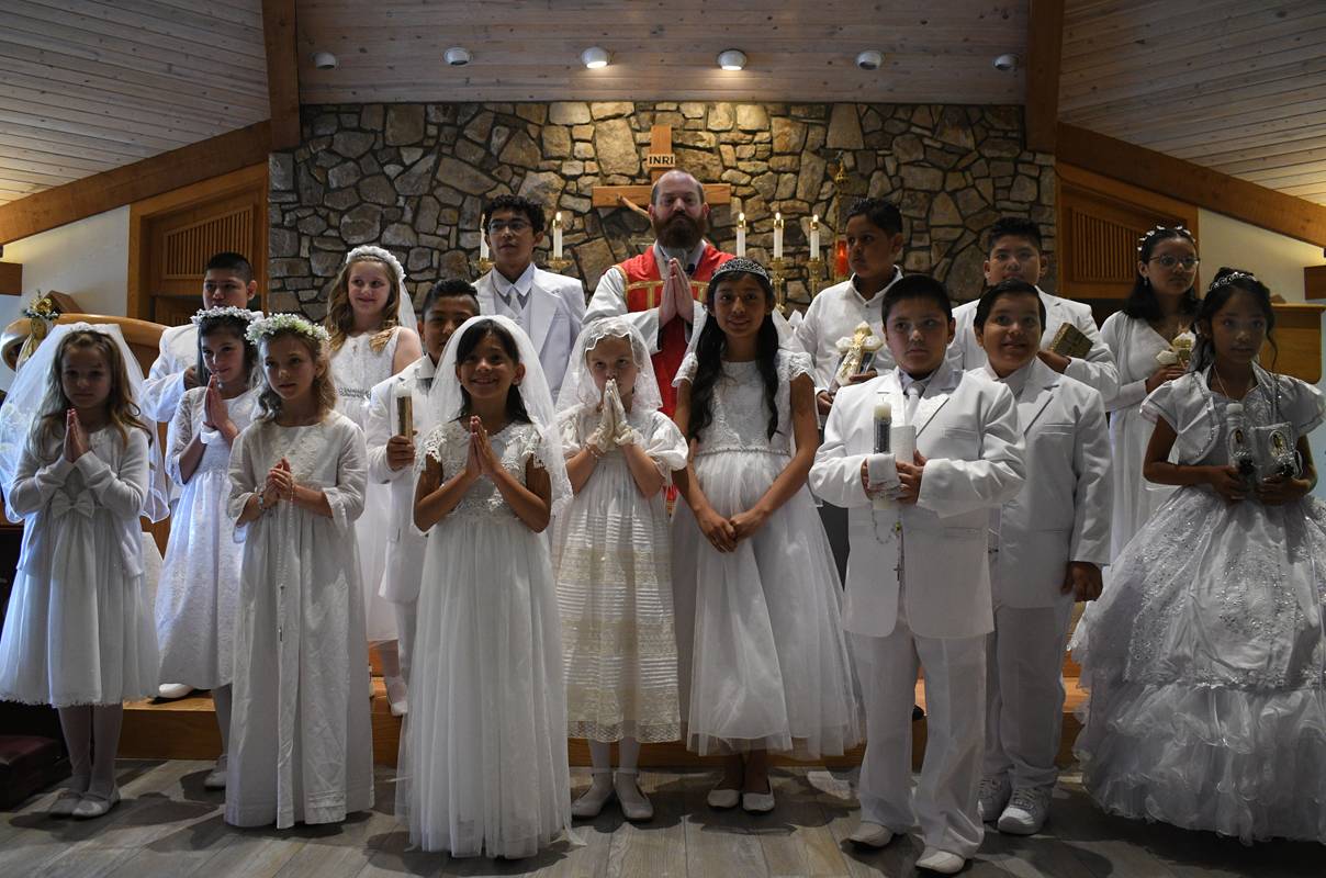 Children at St. Elizabeth Church in Boone received their First Holy Communion May 14. They are pictured with their pastor, Father Brendan Buckler.(Amber Mellon | Catholic News Herald)