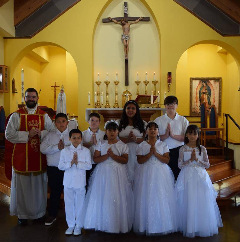 Children at St. John the Evangelist Church in Waynesville received their First Holy Communion May 14. They are pictured with Father Paul McNulty, pastor.(Photo provided by Nicki Conroy)