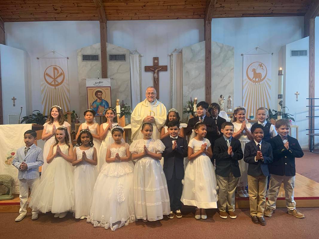Thirty-nine children at St. Luke Parish in Mint Hill received their First Holy Communion during two Masses celebrated May 14 by Father Paul Gary, pastor. (Photos provided by Kathy McKinney)