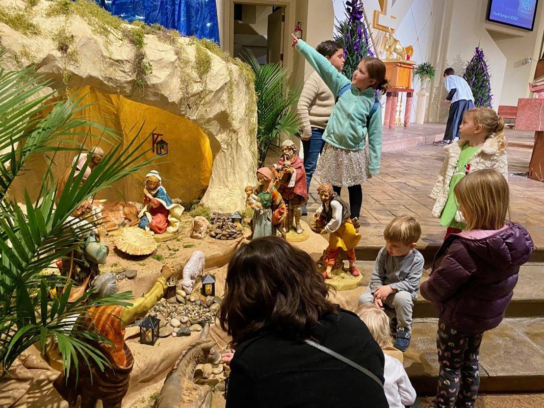 Children at St. Gabriel Church await the coming of the newborn Jesus.
