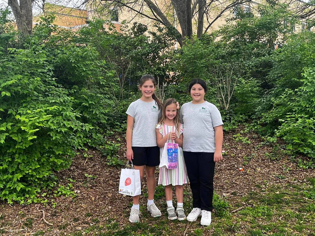 Fourth grade students at St. Leo School help their pre-k prayer partners hunt for Easter eggs. (Provided photos)