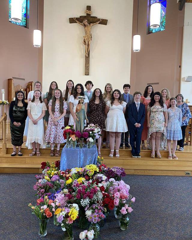 Eighth grade students at Our Lady of Mercy School led the school in honoring and crowning Mary May 12. (Provided photos)