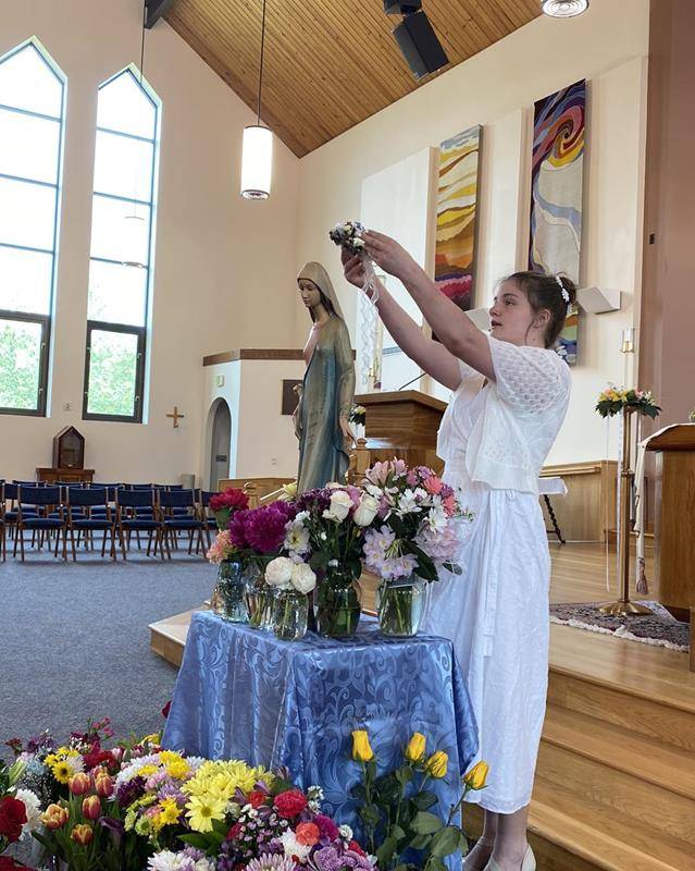 Eighth grade students at Our Lady of Mercy School led the school in honoring and crowning Mary May 12. (Provided photos)