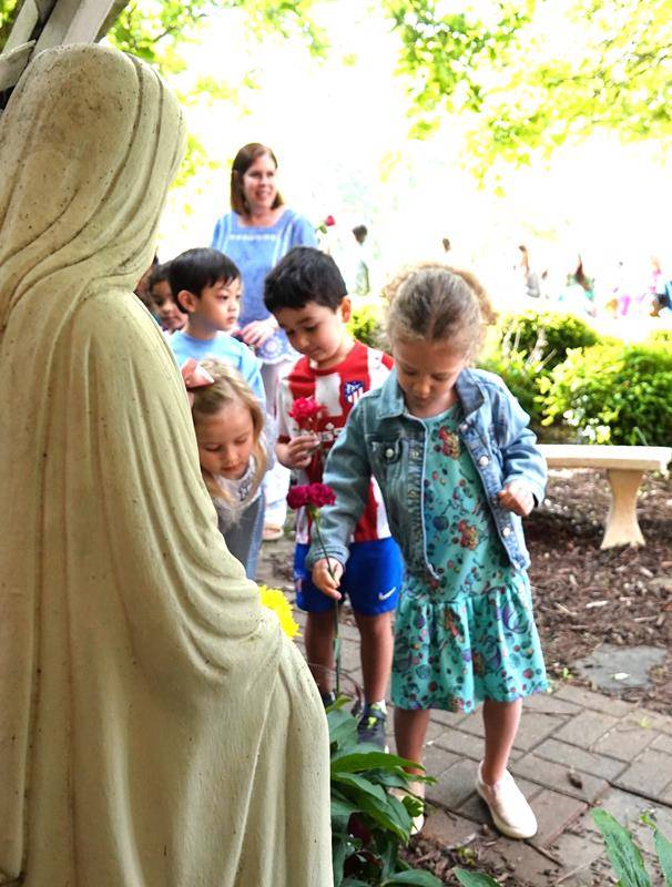 Preschoolers at St. Mark School in Huntersville honored Mary with flowers May 5. Clara Pfister and Owen DeLong crowned Mary. (Photos provided by Amy Burger)
