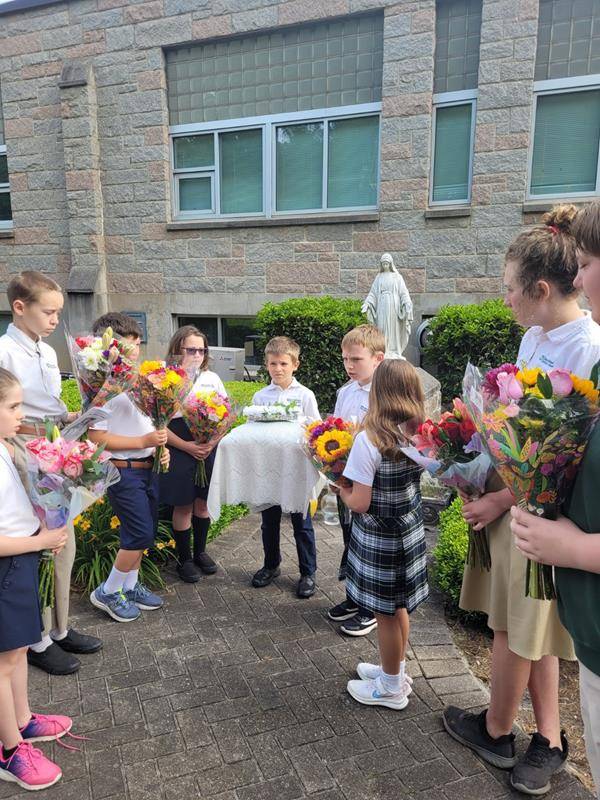 St. Michael School honored Mary with a May Crowning May 11. Saint Michael students sang a beautiful chorus to Mother Mary with verses of