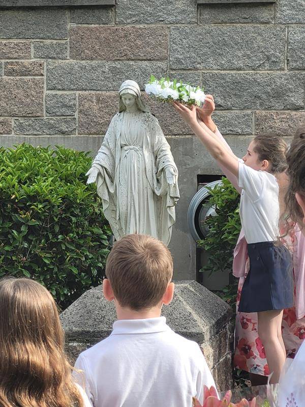 St. Michael School honored Mary with a May Crowning May 11. Saint Michael students sang a beautiful chorus to Mother Mary with verses of