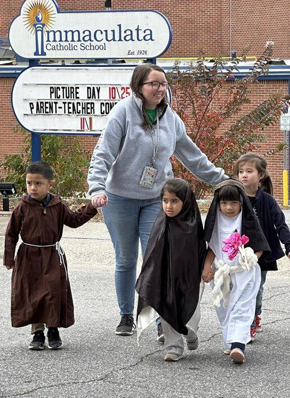 A Saints Parade of students from Immaculata Catholic School processed to Immaculate Conception Church for a lesson on the Litany of the Saints.