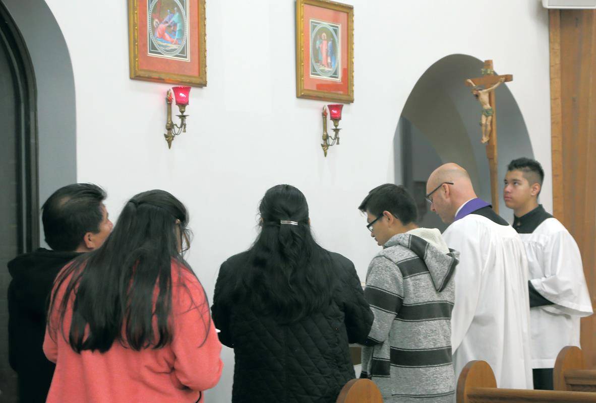 SHELBY — Parishioners at St. Mary, Help of Christians Church prayed the Stations of the Cross in Spanish each Friday during Lent, led by Father Michael Kottar, pastor. Also pictured is cross bearer Cesareo Chavez-Guerrero. (Photo by Giuliana Riley | Catho