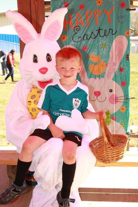 Alex Langford meets the Easter bunny at Holy Cross Church's annual Easter egg hunt (Photo by John Bunyea)