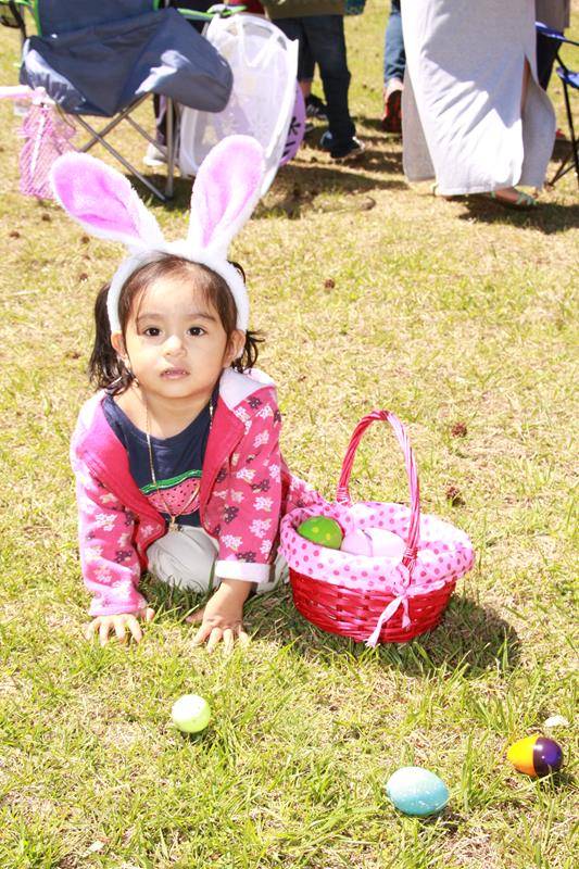 Nancy Juarez, 1, takes part in her first Easter egg hunt at Holy Cross Church (Photo by John Bunyea)