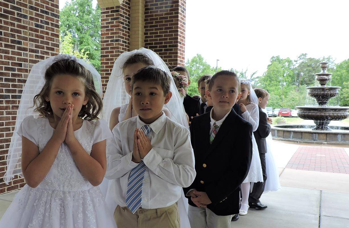 HUNTERSVILLE — This month more than 270 children at St. Mark Church in Huntersville received their first Holy Communion during several Masses celebrated by Father John Putnam, pastor. During his homily at the May 5 Mass, Father Putnam pointed out to the c