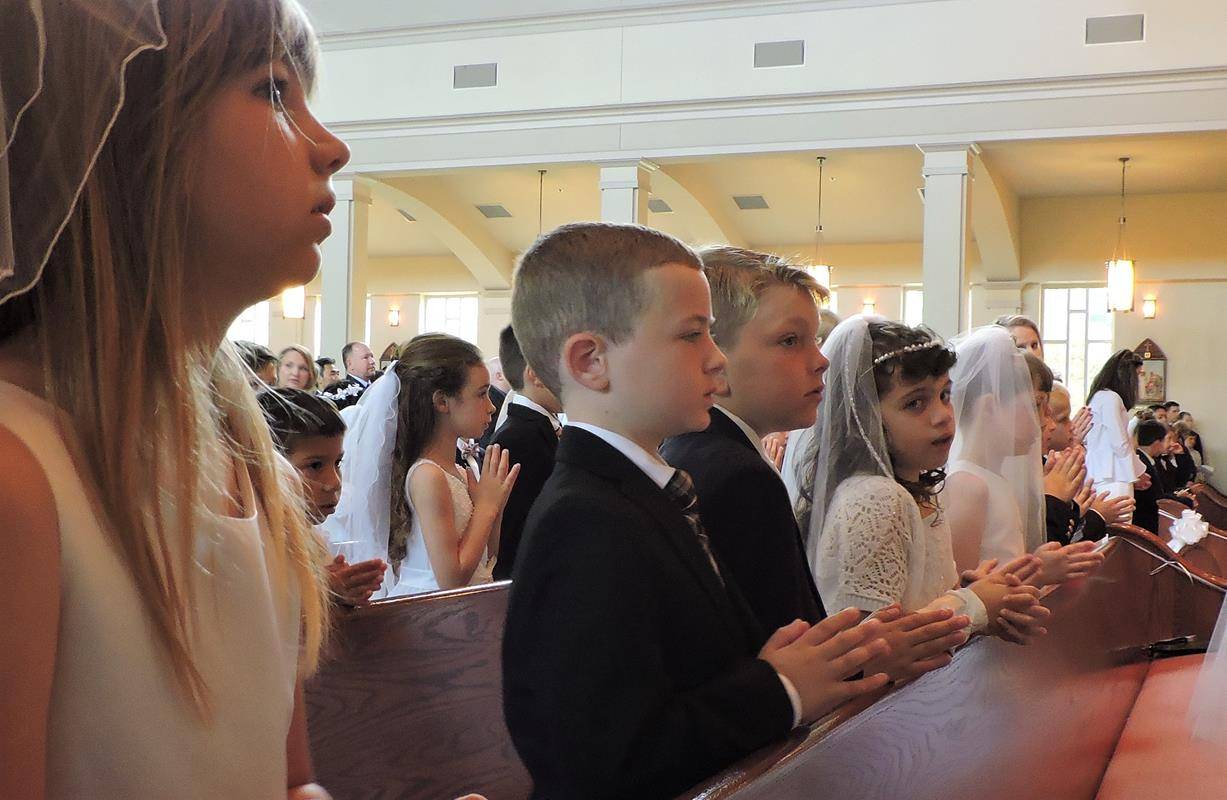 HUNTERSVILLE — This month more than 270 children at St. Mark Church in Huntersville received their first Holy Communion during several Masses celebrated by Father John Putnam, pastor. During his homily at the May 5 Mass, Father Putnam pointed out to the c