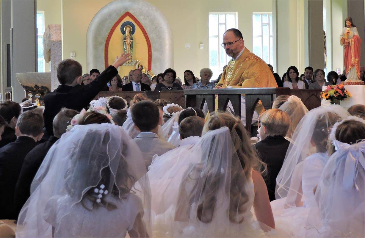 HUNTERSVILLE — This month more than 270 children at St. Mark Church in Huntersville received their first Holy Communion during several Masses celebrated by Father John Putnam, pastor. During his homily at the May 5 Mass, Father Putnam pointed out to the c