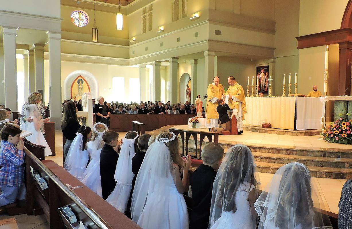 HUNTERSVILLE — This month more than 270 children at St. Mark Church in Huntersville received their first Holy Communion during several Masses celebrated by Father John Putnam, pastor. During his homily at the May 5 Mass, Father Putnam pointed out to the c