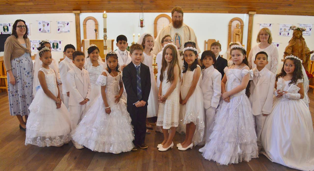 SYLVA — Fater Joshua Voitus, Pastor, of St Mary Catholic Church in Sylva, distributed First Holy Communion to 19 children on May 7. They were: Erika Ambrocio, Ernesto Dominguez, Jany Echevarria, Fatima Fuentes Ornelas, Lucia Ann Gallegos Romero, Ella Ger