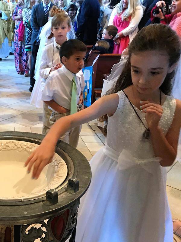 HUNTERSVILLE — This month more than 270 children at St. Mark Church in Huntersville received their first Holy Communion during several Masses celebrated by Father John Putnam, pastor. During his homily at the May 5 Mass, Father Putnam pointed out to the c