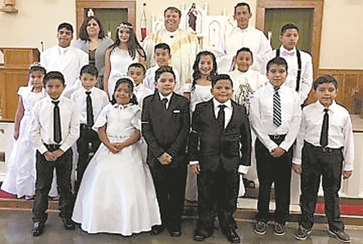 JEFFERSON — Sixteen children at St. Francis of Assisi Church recently received first Communion from their pastor, Father James Stuhrenberg, and Father Camilo, Hispanic coordinator. Not pictured is Mahaley Schuster, who received her first Communion earlier