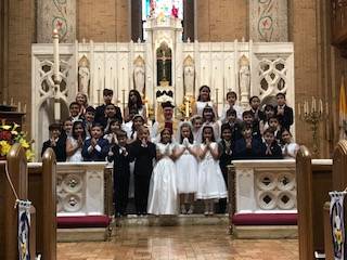 GREENSBORO — Students at Our Lady of Grace School receive their first Communion. (Photo provided by Aphton K. Lang)