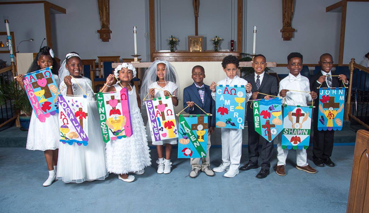 CHARLOTTE — Children at Our Lady of Consolation Church celebrated their first Holy Communion May 20. (Travis Burton | Catholic News Herald)