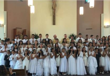 WINSTON-SALEM — Seventy children received their first Holy Communion May 13 at Our Lady of Mercy Church. They also participated in a May Crowning to honor the Blessed Virgin Mary, crowning a statue of Mary and placing flowers at her feet. (Photos provided
