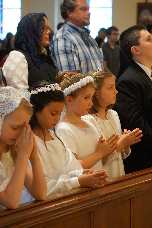 CHARLOTTE — Ten children at St. Ann Church received first Holy Communion April 30 during the parish’s regular Mass in the Extraordinary Form. Father Jason Barone, priest in residence, offered the High Mass, which was accompanied by the St. Ann Schola and