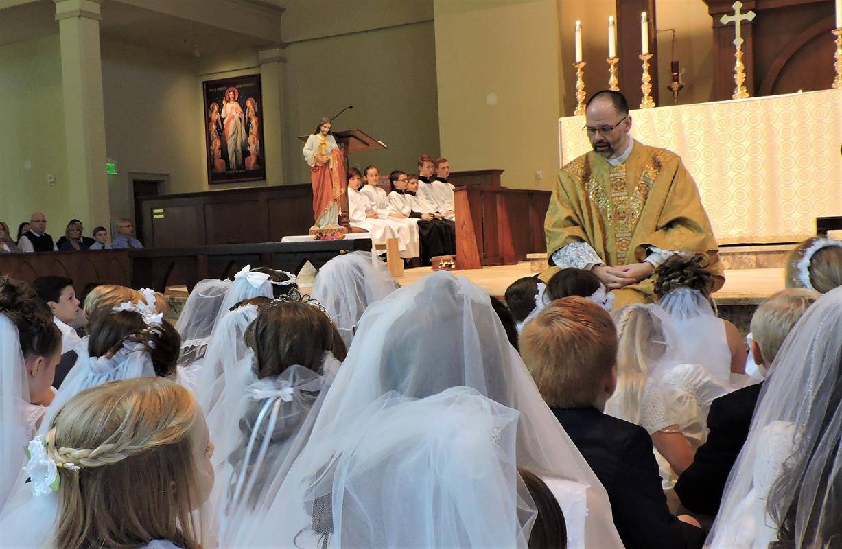 HUNTERSVILLE — This month more than 270 children at St. Mark Church in Huntersville received their first Holy Communion during several Masses celebrated by Father John Putnam, pastor. During his homily at the May 5 Mass, Father Putnam pointed out to the c