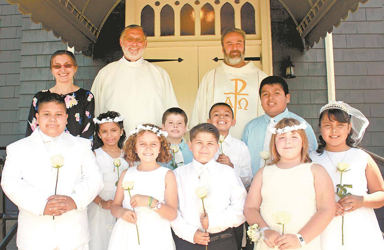 SWANNANOA — Nine children at St. Margaret Mary Church received first Communion during Mass on June 18, the feast of Corpus Christi. Pictured with them are Marta Van Dussen, their faith formation teacher, Deacon Dan Hoffert and Father Matthew Leonard, pas