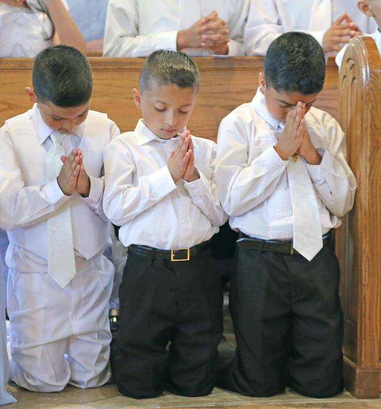 SHELBY — Father Kottar emphasized the sacred occasion of receiving Second Holy Communion. (Photo by Giuliana Polinari Riley)