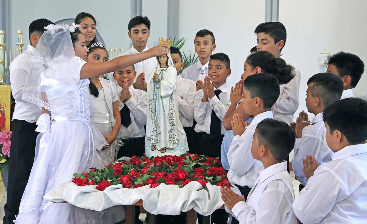 SHELBY — May Crowning was held at St. Mary Help of Christians on May 14 at the 1 p.m. Mass. First Communicants who had received First Communion the previous day, were invited to participate in the ceremony in their First Communion attire. (Photo by Giuli