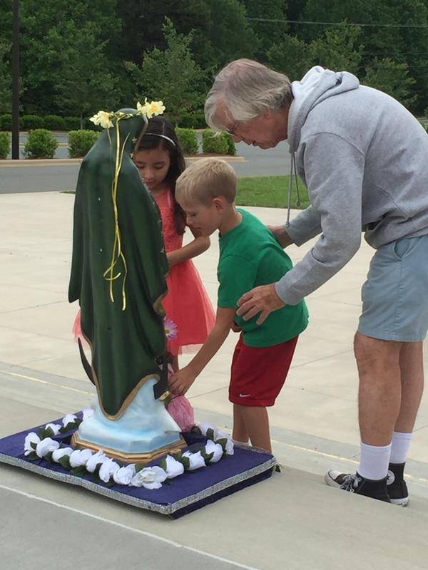 MOORESVILLE — Little Way Preschool at St. Therese Church celebrated May crowning with Father Don Ward on May 11th. (Photo provided by Lisa Cash)