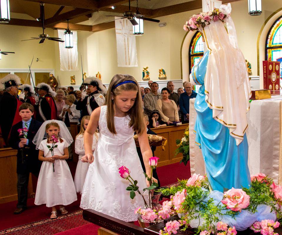 DENVER — For the first time ever, Holy Spirit Church’s Knights of Columbus brought the statue of Mary in at the beginning of Mass and placed her in the sanctuary. Then a group of the parish’s first Communicants placed flowers before the statue, making thi