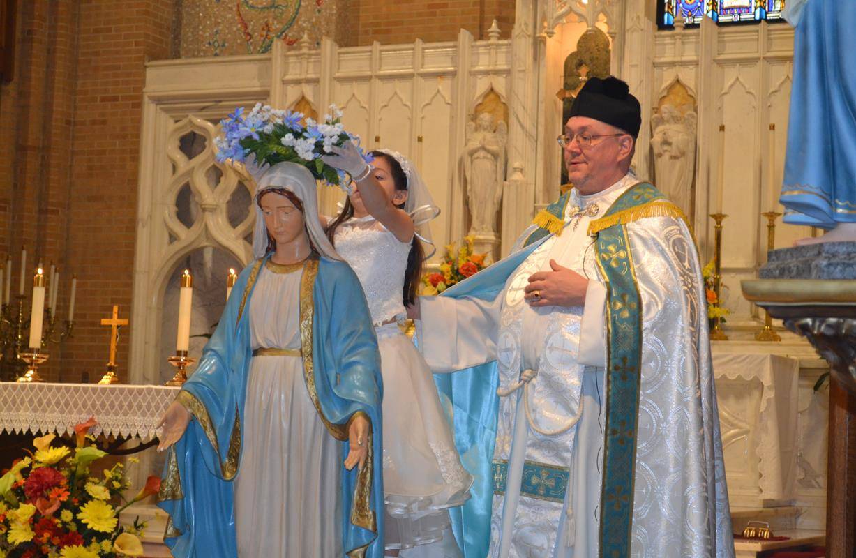 GREENSBORO — Second-grade student Marika Graziani at Our Lady of Grace crowns Our Blessed Mother. (Photo by Joan Sloyan)
