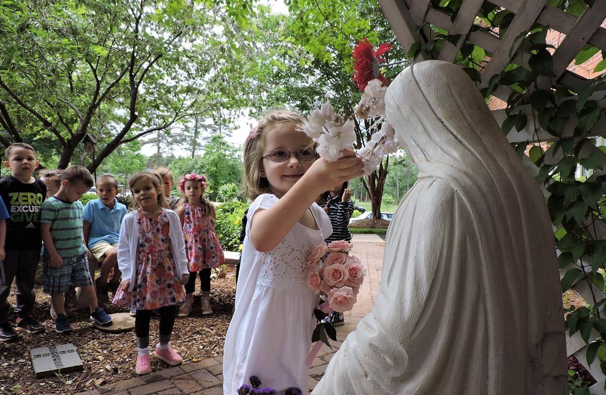 HUNTERSVILLE — St. Mark preschoolers honored Mary with their yearly crowning ceremony May 5. Five-year-old Madeline Fender, the oldest girl in the preschool, had the honor of placing the crown on Mary’s head in the church’s Mary garden while all of the ot